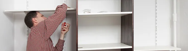 man installing closet shelves