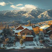 a house with snowcapped mountains in the background
