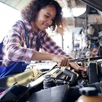 mechanic working on the engine of the car