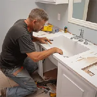 plumber inspecting a bathroom sink