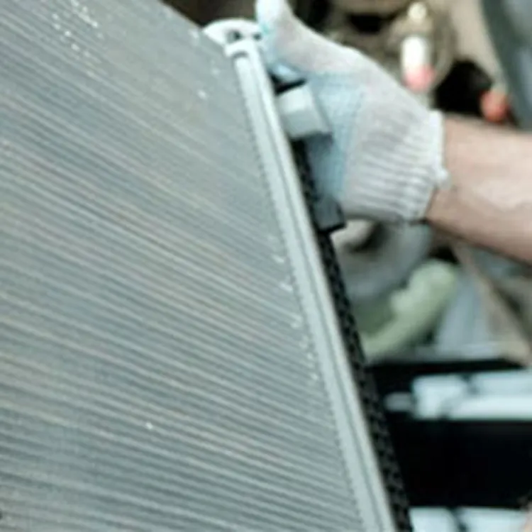 technician replacing radiator