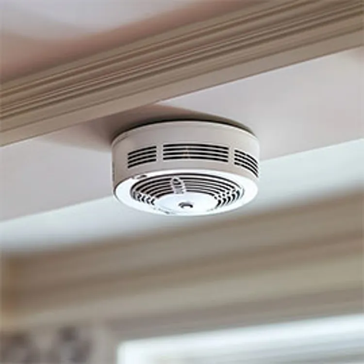 closeup of a smoke detector on a home ceiling
