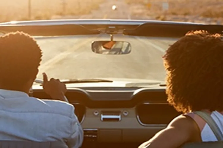 couple driving classic convertible