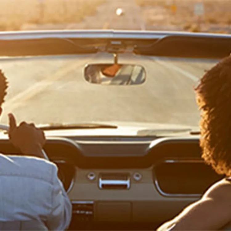 couple driving classic convertible