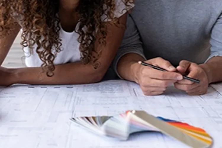 couple looking at house blueprints