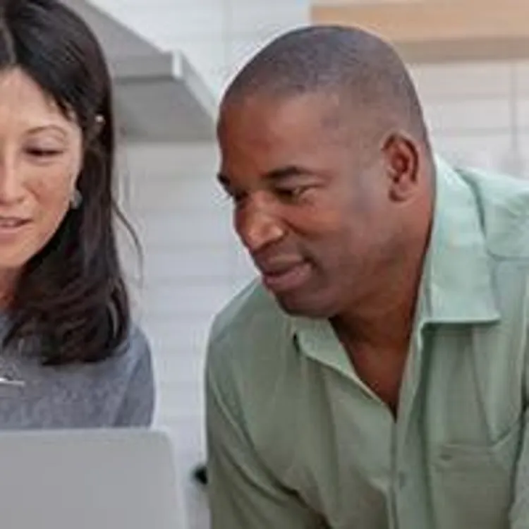 couple researching on laptop