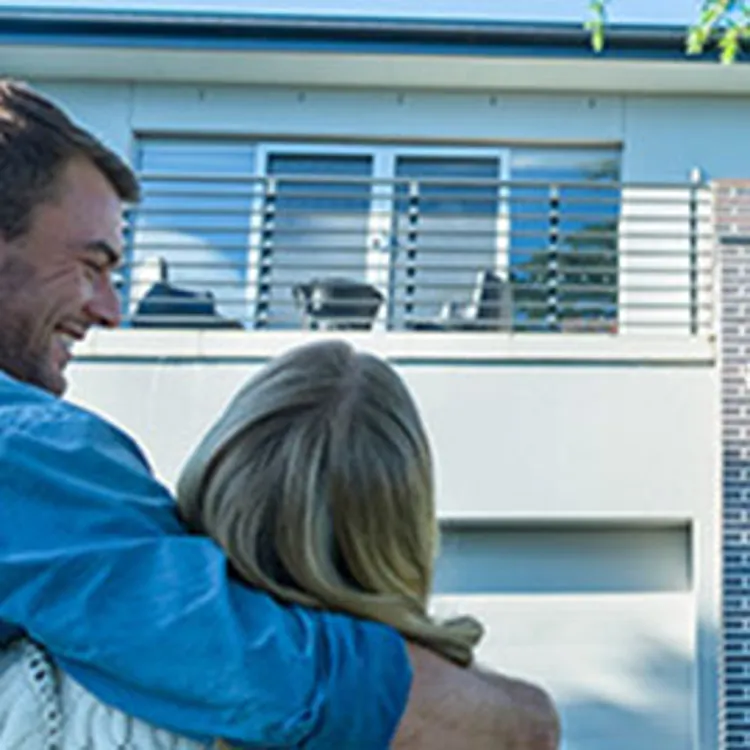 couple standing in front of new home