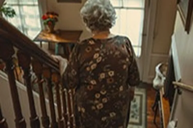 elderly lady climbing down a flight of stairs