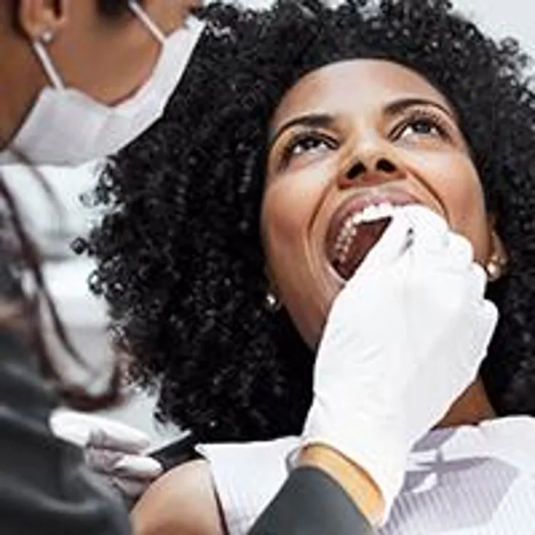 dentist checking womans teeth