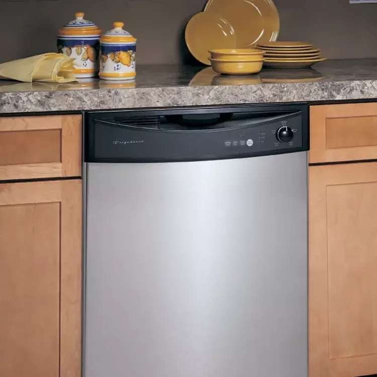 Stainless steel dishwasher installed between wooden cabinets with dishes and jars on the counter