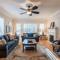 cozy living room with a ceiling fan