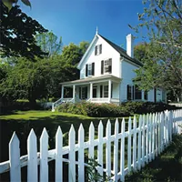 white picket fence around the lawn of a home