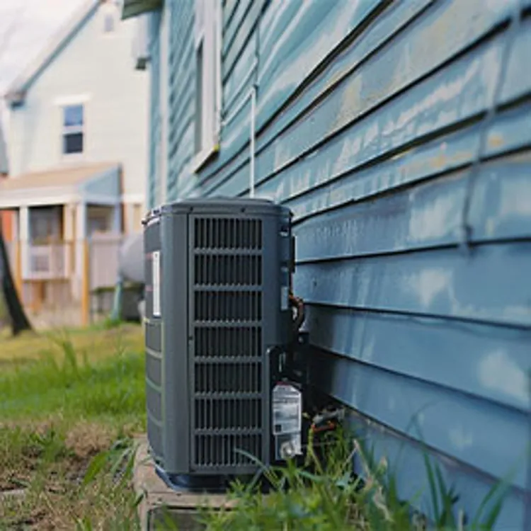 outdoor AC unit at the back of a home