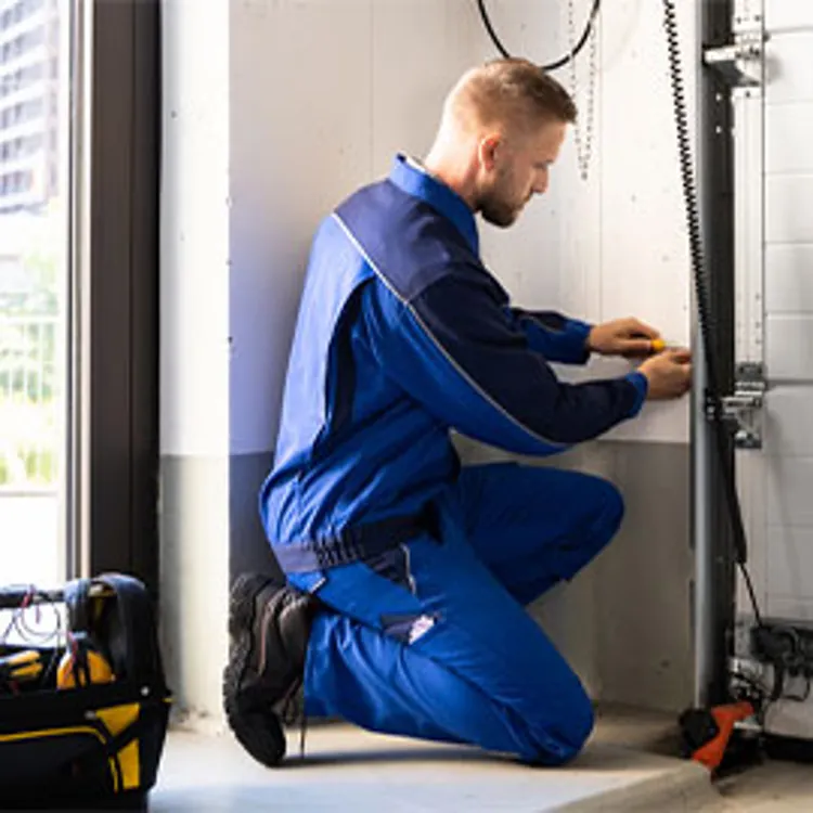 contractor repairing a garage door