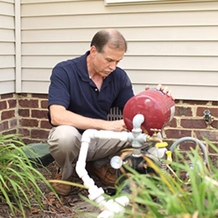 man repairing a well pump