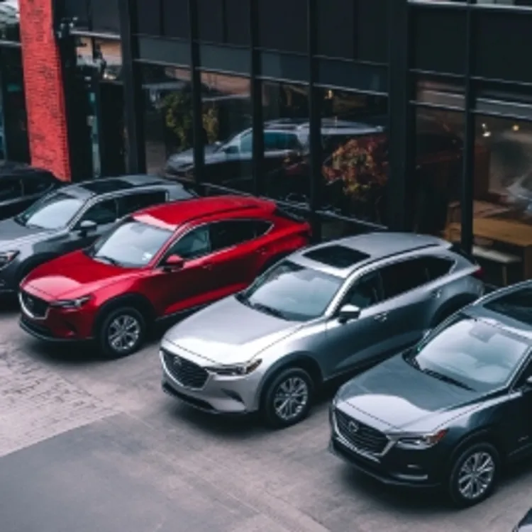 a row of cars parked outside of a dealership