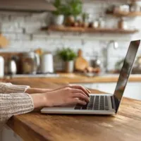 a woman typing on her laptop