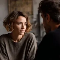 a couple seated and having a conversation