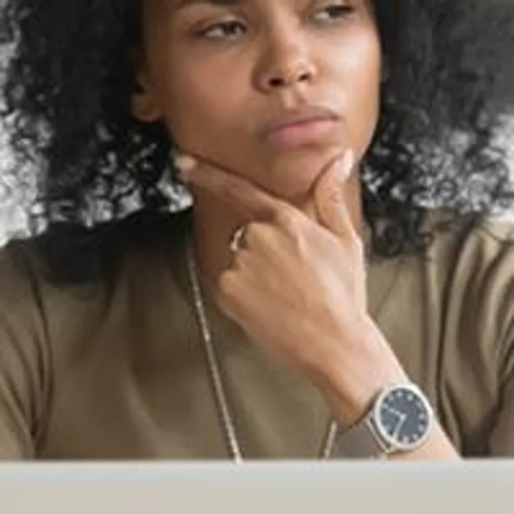 woman looking perplexed while using computer
