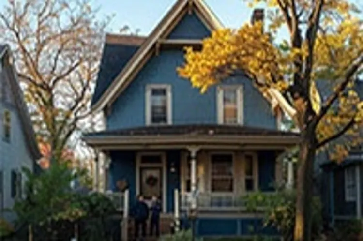 single detached home with a couple standing in front of the porch