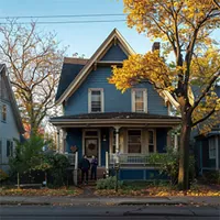 single detached home with a couple standing in front of the porch