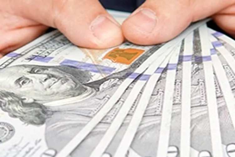 man holding several hundred dollar bills