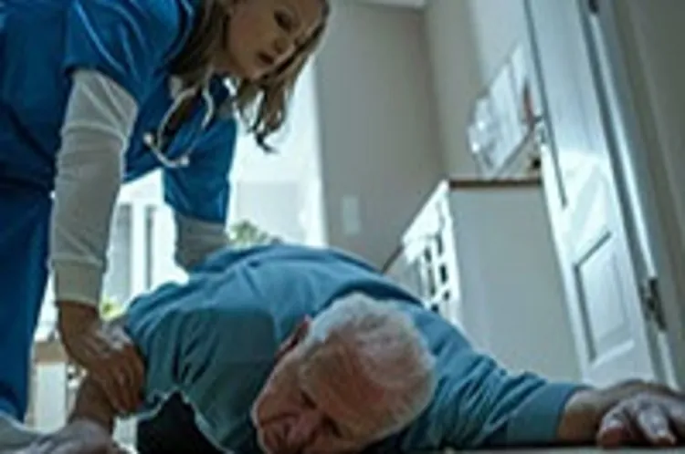 an elderly man on the floor being helped by a caregiver