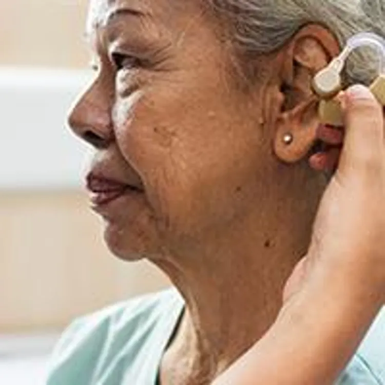 elderly woman with hearing aid