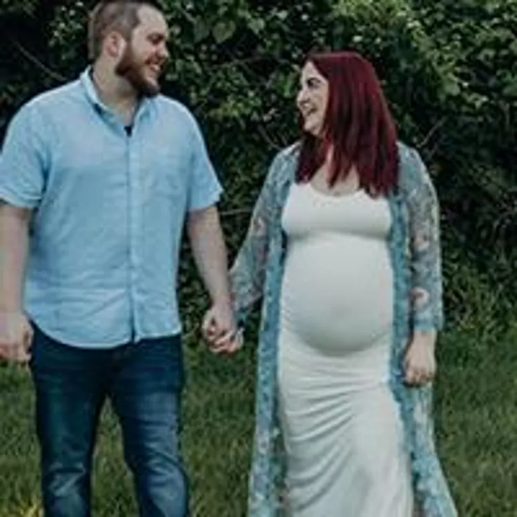 expecting couple holding hands