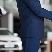 woman shaking hands with car salesman