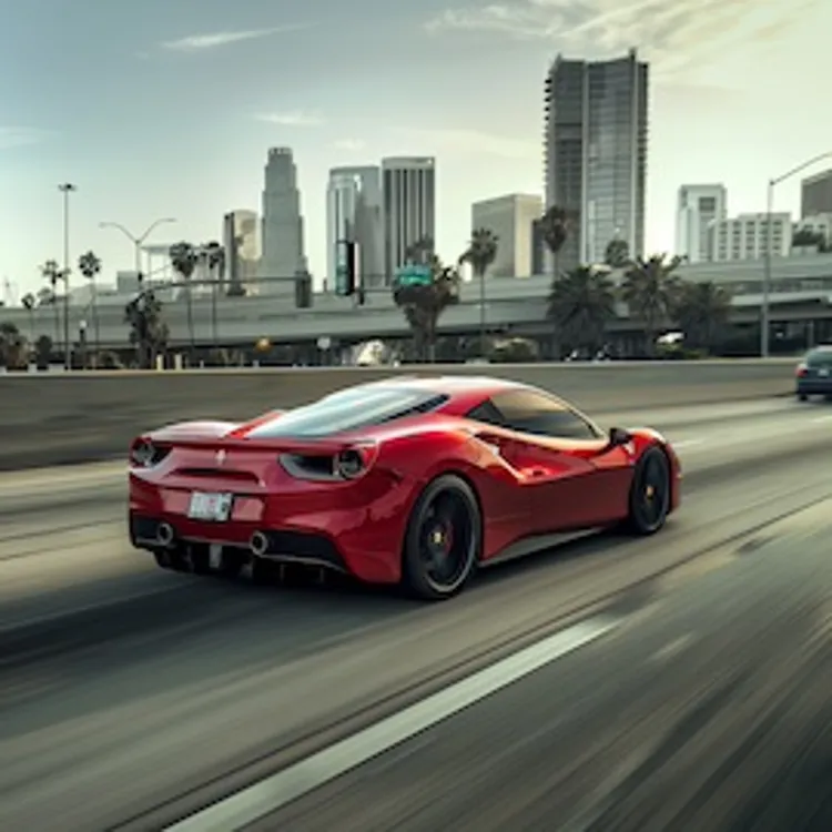 a Ferrari speeding towards the city on a highway