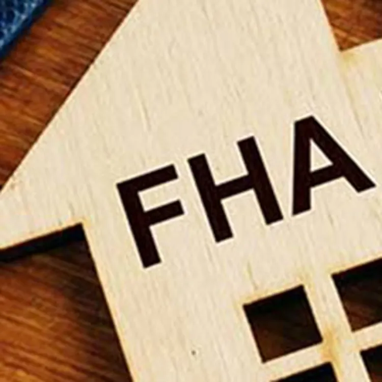 small wooden house with fha loan engraved
