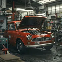 red fiat with an open hood in a shop