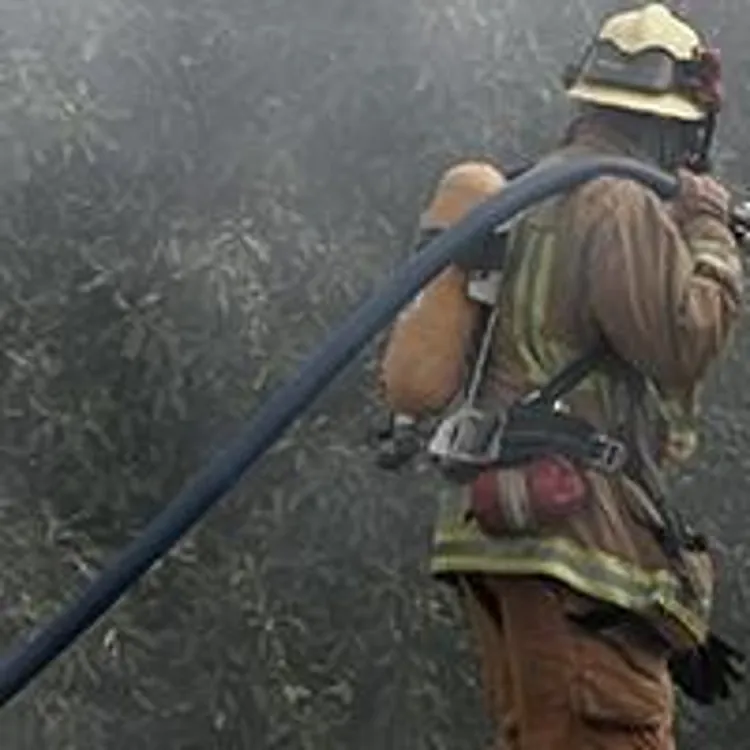 fireman walking with hose