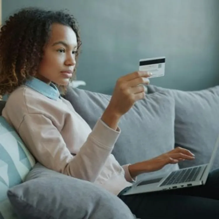 Person with credit card and laptop