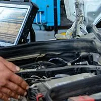 mechanic showing lady customer engine test results