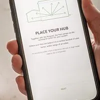 person setting up their frontpoint security system via phone app