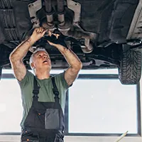 mechanic replacing fuel pump on car