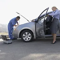 woman waiting for a mechanic to fix her car