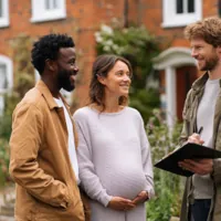 man and pregnant wife talking to a real estate agent