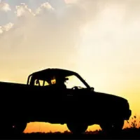 silhouette of pickup truck on the background of beautiful sunset