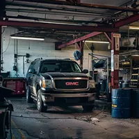 black gmc in a repair shop