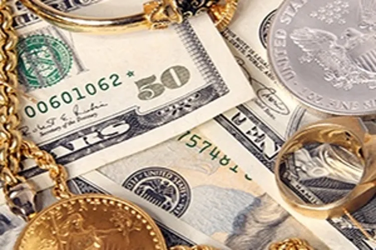 gold and silver coins and accessories laying on money