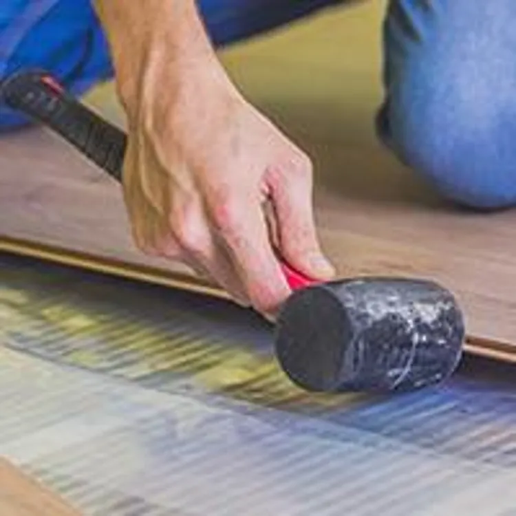man laying hardwood floor