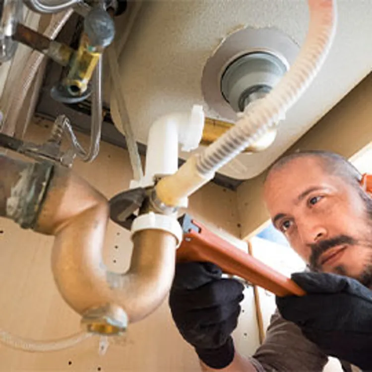 plumbing working under the sink