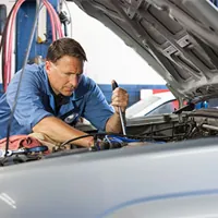 auto mechanic checking car engine