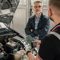 auto mechanic with a customer