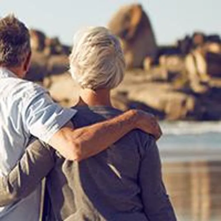 older couple walking on a beach