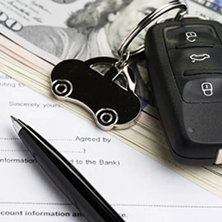 car key remote on top of money and documents