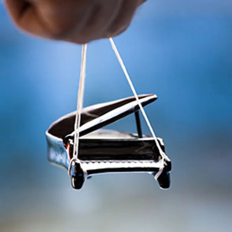 miniature piano with strings attached for transporting